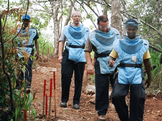 people in a minefield wearing safety spectacles.